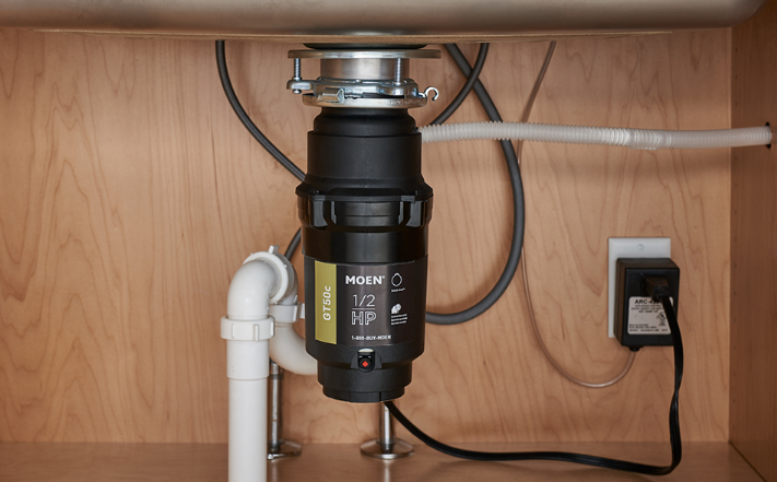 Clean garbage disposal installation under kitchen sink
